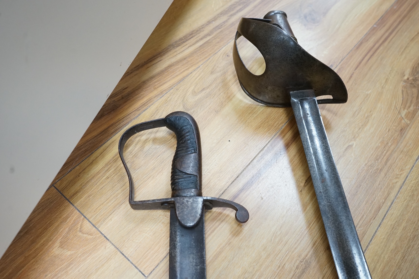 Two swords; a 1796 pattern cavalry troopers regulation pattern sword, the blade stamped W. Deakin, with government inspector’s mark, and regulation hilt, in fair condition, well worn with some light pitting, together wit